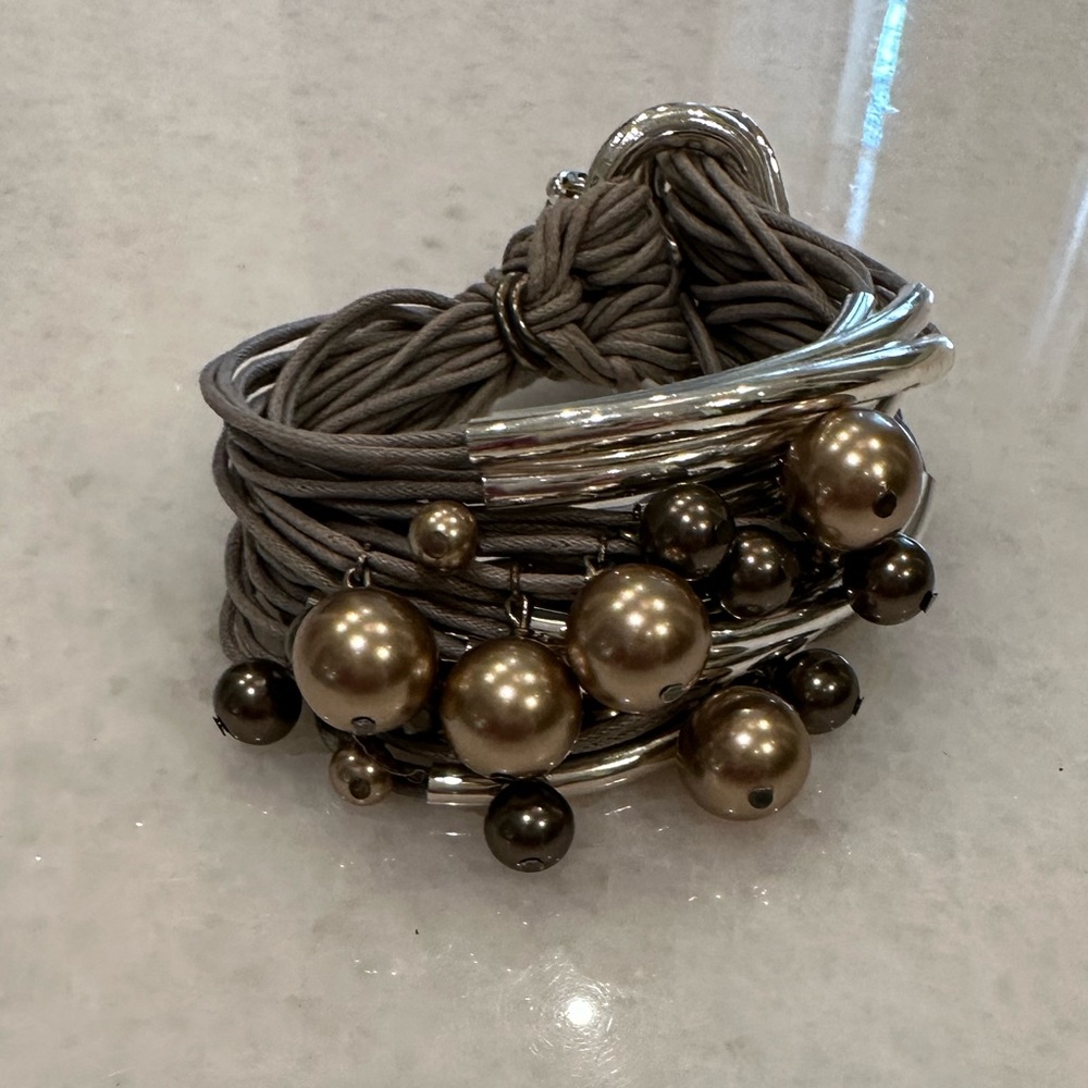 Rope bracelet with pearls and silver hardware.